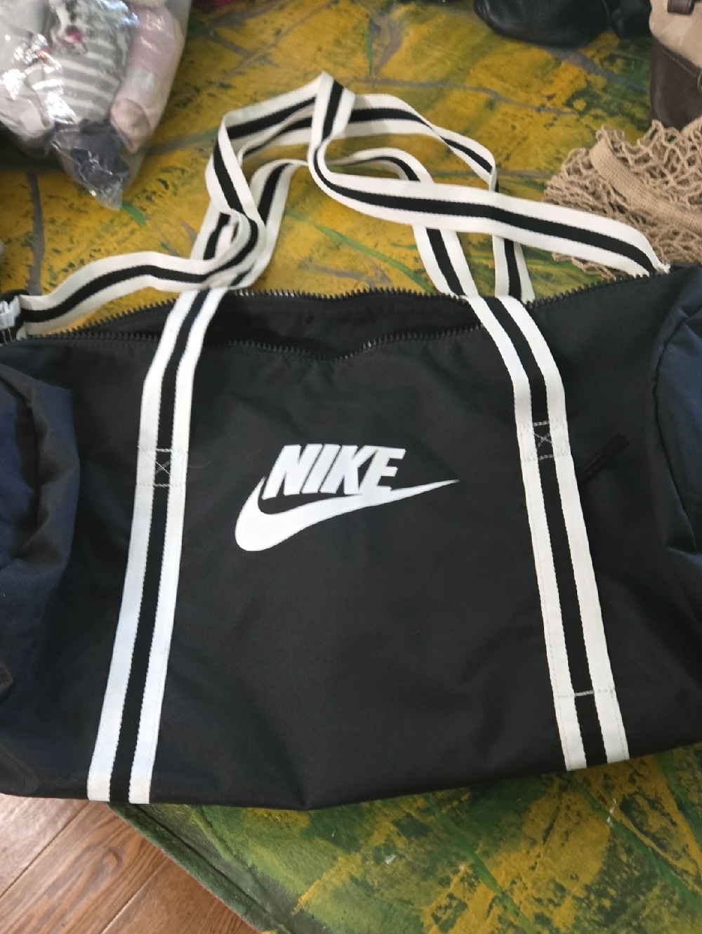 Nike Black Duffel Bag with White Logo and Striped Handles